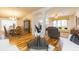 Open concept living room featuring hardwood floors and seamless flow into the dining and Gathering room at 6722 Boulder Run Loop, Wesley Chapel, FL 33545