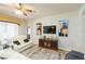 Bright living room featuring hardwood flooring, a ceiling fan, and comfortable seating at 6722 Boulder Run Loop, Wesley Chapel, FL 33545