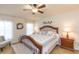 Inviting bedroom featuring a ceiling fan, windows, and a wood frame bed at 6722 Boulder Run Loop, Wesley Chapel, FL 33545