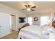 Bedroom featuring a ceiling fan, windows, and an ensuite bathroom at 6722 Boulder Run Loop, Wesley Chapel, FL 33545