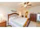 Comfortable main bedroom featuring a ceiling fan, dresser, and private access to the ensuite bath at 6722 Boulder Run Loop, Wesley Chapel, FL 33545