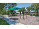 Community playground featuring a shaded play structure, swings, and wood chip ground cover at 6722 Boulder Run Loop, Wesley Chapel, FL 33545