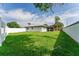 Large grassy backyard with white vinyl fence at 734 Fortuna Dr, Brandon, FL 33511