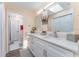 Modern bathroom with double vanity, white cabinets, and quartz countertop at 734 Fortuna Dr, Brandon, FL 33511