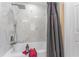 Updated bathroom with marble tile shower and gray shower curtain at 734 Fortuna Dr, Brandon, FL 33511