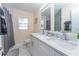 Updated bathroom with double vanity, white cabinets and a view into another room at 734 Fortuna Dr, Brandon, FL 33511