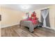 Spacious bedroom with gray bedding and dark wood flooring at 734 Fortuna Dr, Brandon, FL 33511