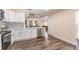 Modern kitchen with white shaker cabinets, stainless steel appliances, and gray backsplash at 734 Fortuna Dr, Brandon, FL 33511