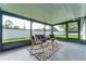 Relaxing screened porch with patio furniture at 734 Fortuna Dr, Brandon, FL 33511