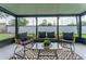 Screened porch with wicker furniture and a glass-top table at 734 Fortuna Dr, Brandon, FL 33511