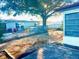 Backyard with gravel ground cover, partial fence, and a tree providing shade at 7614 Karen Dr, Port Richey, FL 34668