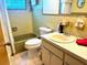 Clean bathroom with tub, toilet and vanity with sink at 7614 Karen Dr, Port Richey, FL 34668