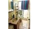 Small bathroom with shower, toilet, sink, and storage shelving at 7614 Karen Dr, Port Richey, FL 34668
