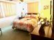 Spacious bedroom with a queen-size bed and ample natural light at 7614 Karen Dr, Port Richey, FL 34668