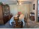Bright dining room featuring a table with seating for six and a vintage hutch at 7614 Karen Dr, Port Richey, FL 34668