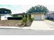 Front view of a house with a driveway and lawn at 7614 Karen Dr, Port Richey, FL 34668