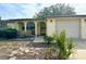 Ranch-style home with attached garage and mature landscaping at 7614 Karen Dr, Port Richey, FL 34668