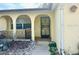 Front entry with arched walkway and decorative door at 7614 Karen Dr, Port Richey, FL 34668
