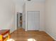 Hardwood floor bedroom with closet and door to hallway at 805 Anchors Way, Tarpon Springs, FL 34689