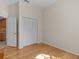 Hardwood floor bedroom with closet and door to hallway at 805 Anchors Way, Tarpon Springs, FL 34689