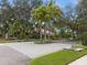 Westwinds community entrance with palm trees and brick road at 805 Anchors Way, Tarpon Springs, FL 34689