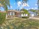 House exterior showcasing landscaping and a two-car garage at 805 Anchors Way, Tarpon Springs, FL 34689