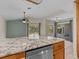 Kitchen with granite island and views of the backyard pool at 805 Anchors Way, Tarpon Springs, FL 34689