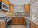 Updated kitchen featuring wood cabinets and granite countertops at 805 Anchors Way, Tarpon Springs, FL 34689