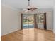 Main bedroom with hardwood floors and sliding doors to pool at 805 Anchors Way, Tarpon Springs, FL 34689