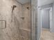 Large walk-in shower with tile surround and pebble floor at 805 Anchors Way, Tarpon Springs, FL 34689