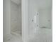 Bathroom featuring walk-in shower with gray tile, modern fixtures, and an open doorway at 870 29Th N Ave, St Petersburg, FL 33704