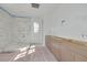 Bright bathroom features marble tiled shower and custom wood cabinets at 870 29Th N Ave, St Petersburg, FL 33704
