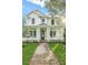 Inviting two-story home boasts a covered front porch with craftsman columns and landscaped lawn at 870 29Th N Ave, St Petersburg, FL 33704