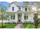 Inviting two-story home boasts a covered front porch with craftsman columns and landscaped lawn at 870 29Th N Ave, St Petersburg, FL 33704
