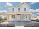 Two-story home boasts large windows and a covered front porch with columns, showcasing its classic design at 870 29Th N Ave, St Petersburg, FL 33704