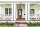 Charming front porch features a stylish hanging lantern and craftsman-style columns, complementing the exterior at 870 29Th N Ave, St Petersburg, FL 33704