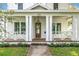 Charming front porch features a stylish hanging lantern and craftsman-style columns, complementing the exterior at 870 29Th N Ave, St Petersburg, FL 33704