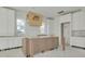 Bright kitchen with a custom wood range hood and modern white cabinetry being installed at 870 29Th N Ave, St Petersburg, FL 33704