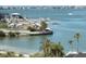 Scenic view of the marina, featuring clear blue water, boat docks, and lush palm trees at 100 Bluff View Dr # 401A, Belleair Bluffs, FL 33770