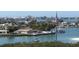 Picturesque aerial view showcasing waterfront homes, docks, and lush greenery in a serene coastal community at 100 Bluff View Dr # 401A, Belleair Bluffs, FL 33770
