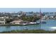 Captivating aerial view of waterfront homes, boat docks, and lush landscaping in a peaceful coastal community at 100 Bluff View Dr # 401A, Belleair Bluffs, FL 33770