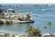 Scenic view of the marina, featuring clear blue water, boat docks, and lush palm trees at 100 Bluff View Dr # 401A, Belleair Bluffs, FL 33770