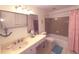 Bathroom featuring a vanity with sink, vanity mirror and shower with curtain at 100 Bluff View Dr # 401A, Belleair Bluffs, FL 33770