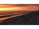 Beautiful beach view with a bright sunset over the ocean waters at 100 Bluff View Dr # 401A, Belleair Bluffs, FL 33770