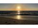 Serene sunset casting a golden glow over a tranquil beach, creating a picturesque and inviting coastal scene at 100 Bluff View Dr # 401A, Belleair Bluffs, FL 33770