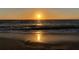 Gorgeous sunset scene over sandy beach with sparkling water, creating a serene and picturesque coastal experience at 100 Bluff View Dr # 401A, Belleair Bluffs, FL 33770