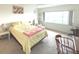 Bedroom with a large window providing natural light, plush carpet, and comfortable furniture at 100 Bluff View Dr # 401A, Belleair Bluffs, FL 33770
