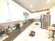 Functional kitchen featuring white appliances, granite countertops, and tile flooring at 100 Bluff View Dr # 401A, Belleair Bluffs, FL 33770