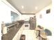 Functional kitchen featuring white appliances, granite countertops, and tile flooring at 100 Bluff View Dr # 401A, Belleair Bluffs, FL 33770