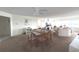 Spacious open-concept living and dining area with a ceiling fan and large windows at 100 Bluff View Dr # 401A, Belleair Bluffs, FL 33770